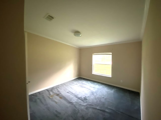 empty room with dark colored carpet and crown molding