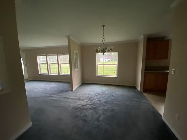 interior space featuring dark carpet, crown molding, and a chandelier