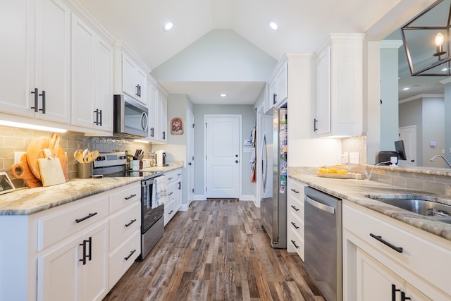 kitchen with white cabinetry, lofted ceiling, dark wood-style floors, and appliances with stainless steel finishes