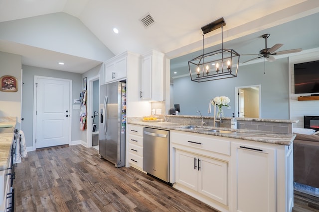 kitchen with visible vents, a sink, open floor plan, dark wood finished floors, and stainless steel appliances