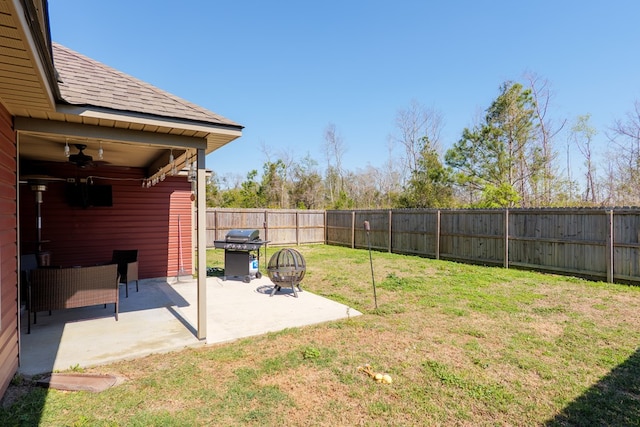 view of yard with a fenced backyard, a ceiling fan, and a patio area