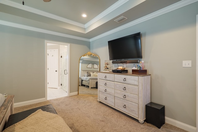 bedroom with baseboards, visible vents, a tray ceiling, ornamental molding, and light carpet