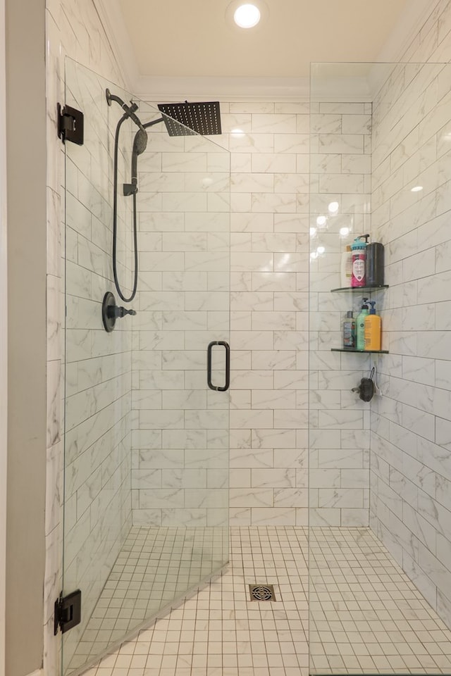 full bathroom featuring a stall shower and crown molding