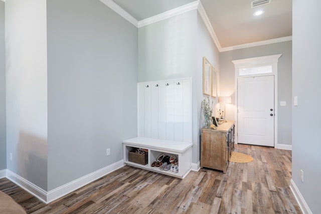 mudroom featuring visible vents, baseboards, wood finished floors, and ornamental molding