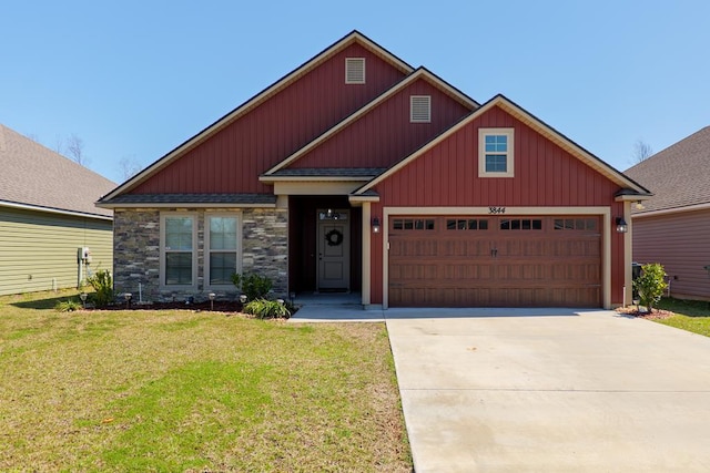 craftsman house featuring stone siding, an attached garage, concrete driveway, and a front yard