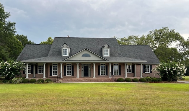 view of front of house with a porch and a front lawn