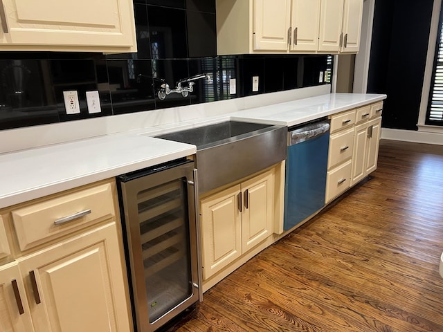 kitchen with sink, wine cooler, stainless steel dishwasher, tasteful backsplash, and dark hardwood / wood-style flooring