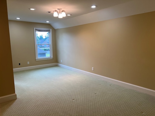 unfurnished room featuring lofted ceiling and carpet floors