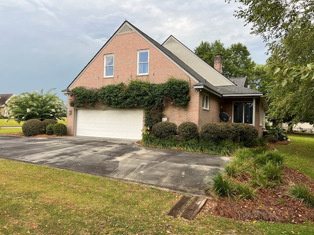 view of front of home with a garage and a front lawn