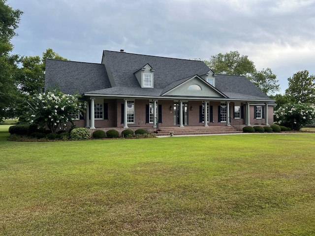 view of front of home with covered porch and a front lawn