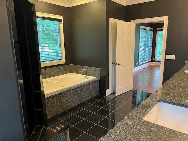 bathroom with hardwood / wood-style flooring, vanity, a tub to relax in, and crown molding