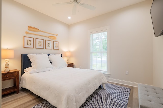 bedroom featuring ceiling fan and light hardwood / wood-style flooring