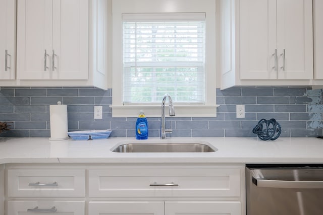 kitchen with white cabinetry, sink, and dishwasher