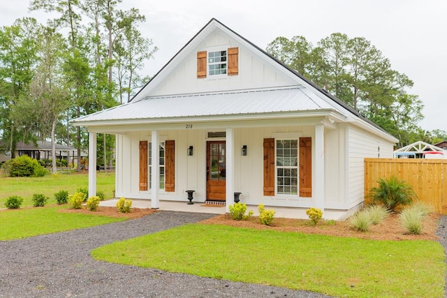 view of front of property with a porch and a front lawn