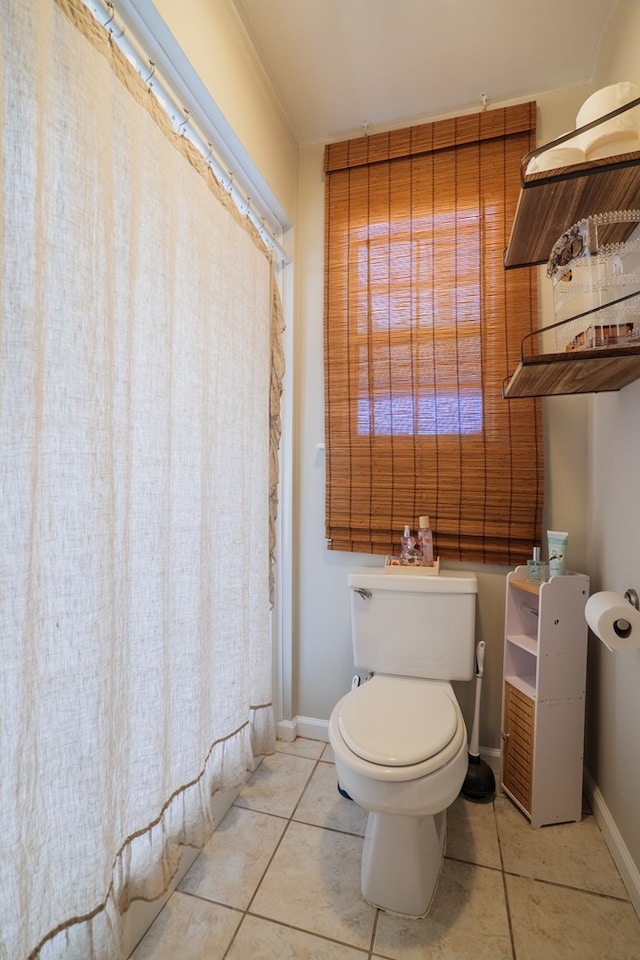 bathroom featuring tile patterned floors and toilet