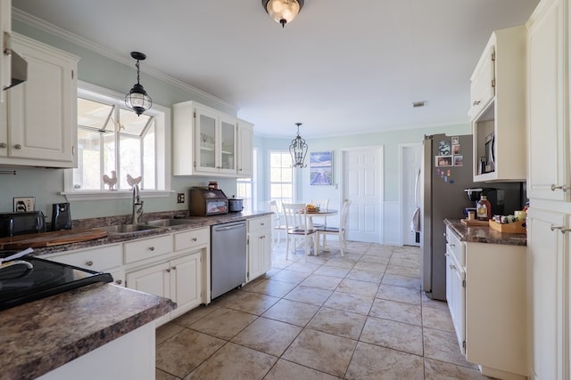 kitchen with appliances with stainless steel finishes, decorative light fixtures, and white cabinets