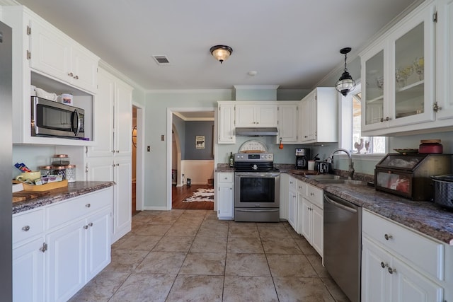 kitchen with sink, white cabinetry, dark stone countertops, pendant lighting, and stainless steel appliances