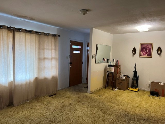 view of carpeted foyer entrance