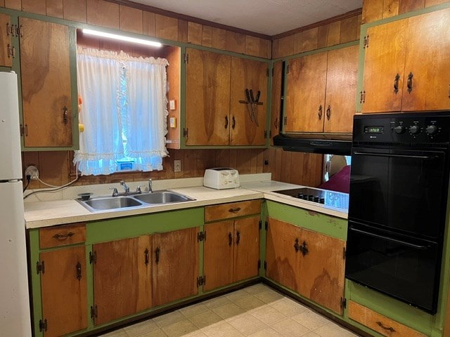 kitchen featuring double oven, sink, extractor fan, and white refrigerator