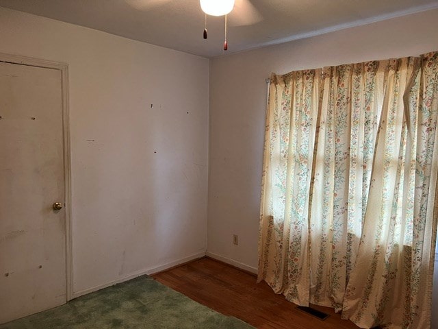 spare room featuring ceiling fan and wood-type flooring