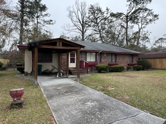 ranch-style home with a front yard and a carport