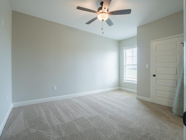 unfurnished room with light carpet and ceiling fan