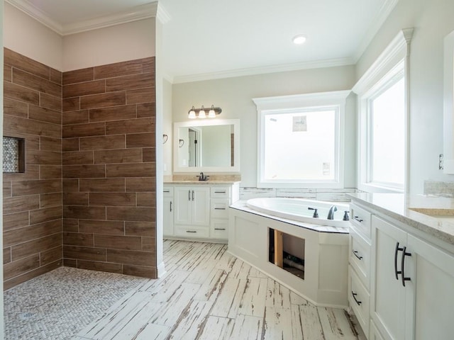 bathroom with vanity, a bathtub, and crown molding