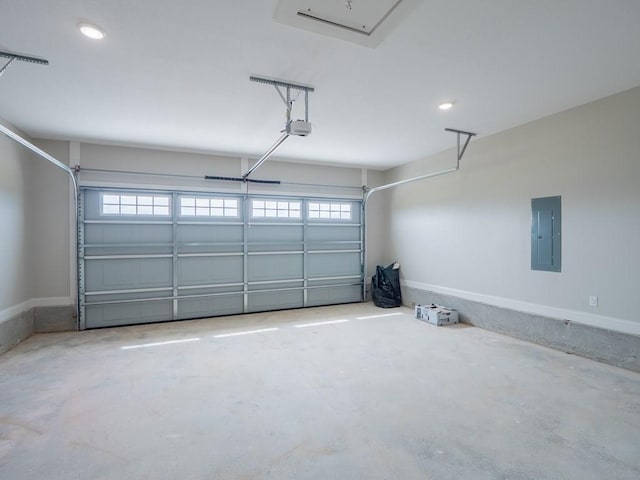 garage with a garage door opener and electric panel