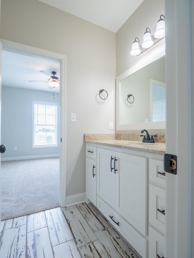 bathroom with ceiling fan and vanity