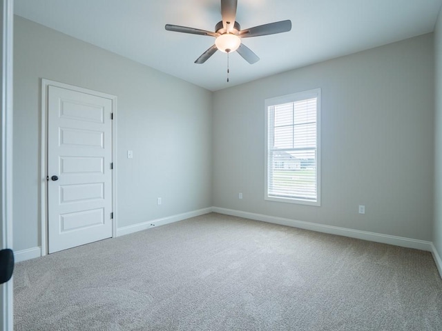 empty room with carpet and ceiling fan