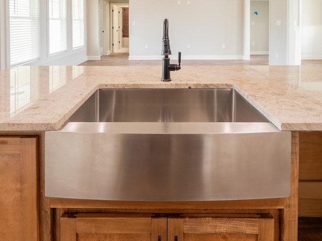 room details featuring light stone countertops and sink