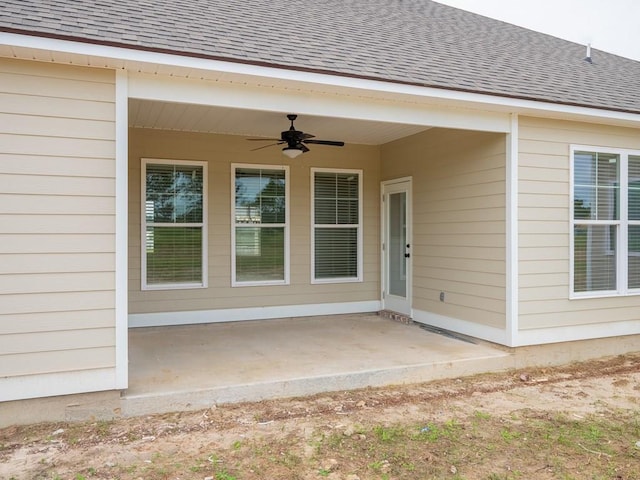 view of exterior entry with a patio area and ceiling fan