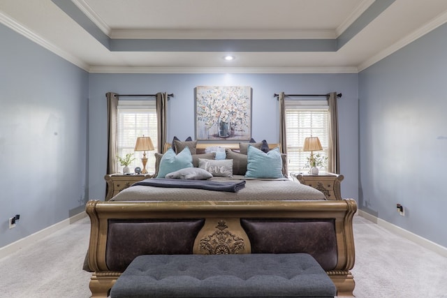 carpeted bedroom with crown molding and a tray ceiling