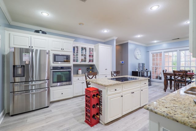 kitchen featuring white cabinets, appliances with stainless steel finishes, and light stone counters