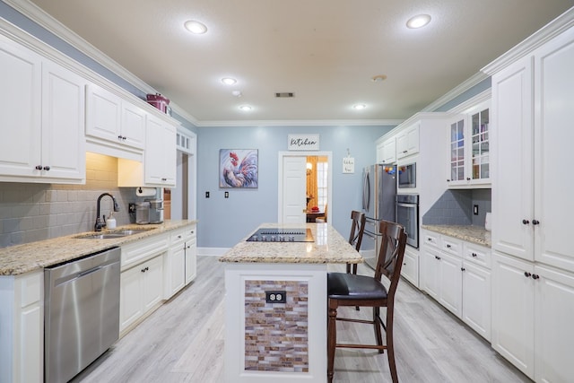 kitchen featuring white cabinets, appliances with stainless steel finishes, tasteful backsplash, and sink