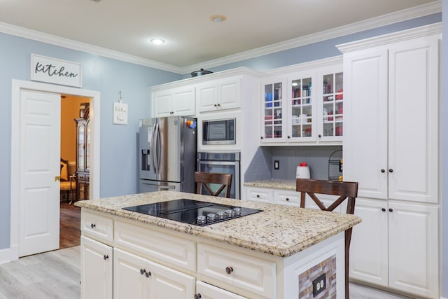 kitchen featuring light hardwood / wood-style floors, white cabinets, ornamental molding, and appliances with stainless steel finishes