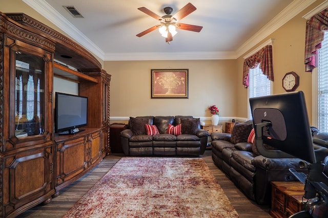 living room with dark hardwood / wood-style flooring, ceiling fan, and crown molding