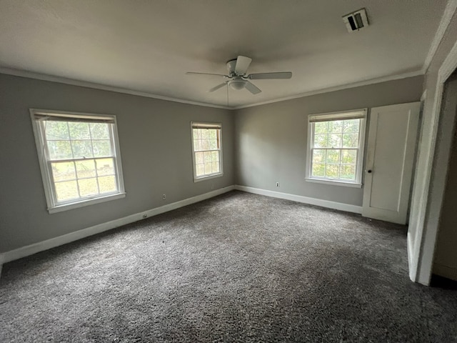 carpeted spare room with ceiling fan, ornamental molding, visible vents, and baseboards