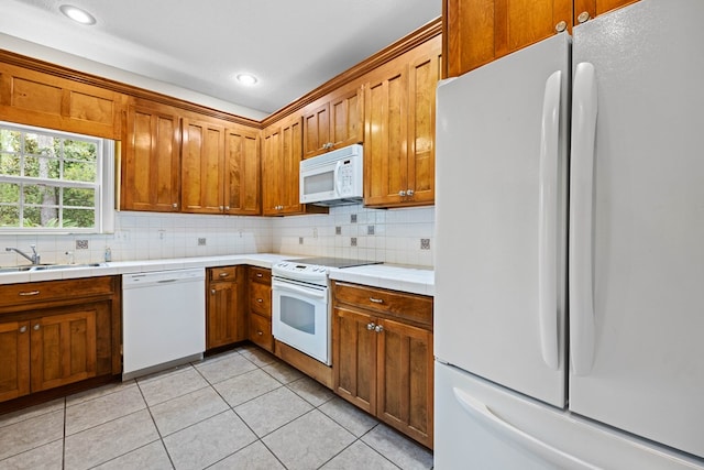 4143 Whithorn Way, Valdosta, GA 31605 - kitchen featuring white appliances, a sink, decorative backsplash, brown cabinetry, and recessed lighting