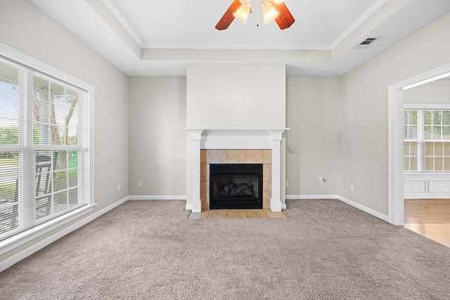 4143 Whithorn Way, Valdosta, GA 31605 - unfurnished living room with carpet flooring, a tile fireplace, ceiling fan, a tray ceiling, and crown molding