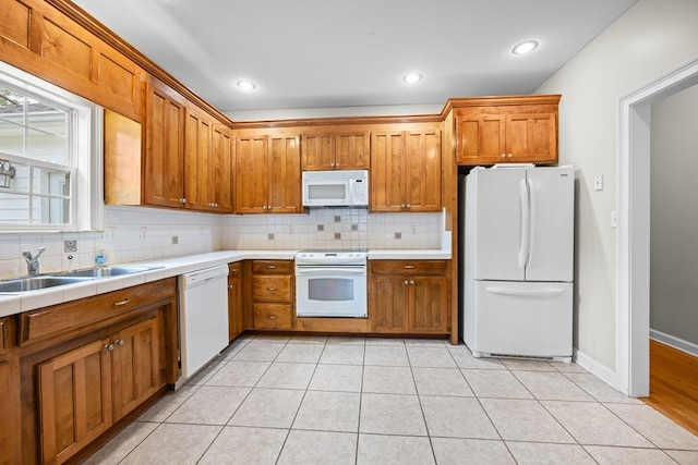 4143 Whithorn Way, Valdosta, GA 31605 - kitchen featuring white appliances, tasteful backsplash, brown cabinetry, and recessed lighting