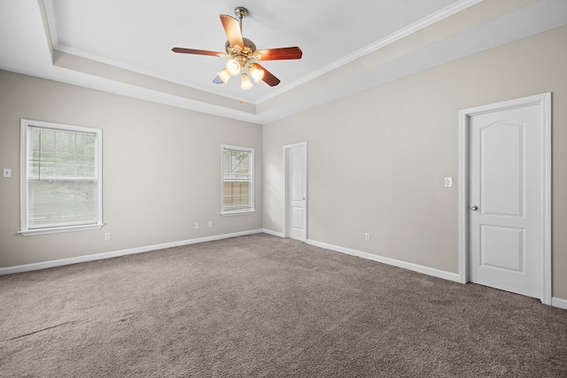 4143 Whithorn Way, Valdosta, GA 31605 - empty room featuring a tray ceiling, carpet flooring, crown molding, a ceiling fan, and baseboards