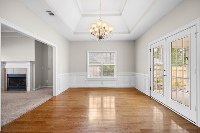 4143 Whithorn Way, Valdosta, GA 31605 - unfurnished dining area with a raised ceiling, a chandelier, hardwood / wood-style floors, wainscoting, and a fireplace