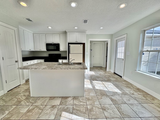 kitchen featuring white cabinets, sink, plenty of natural light, and black appliances