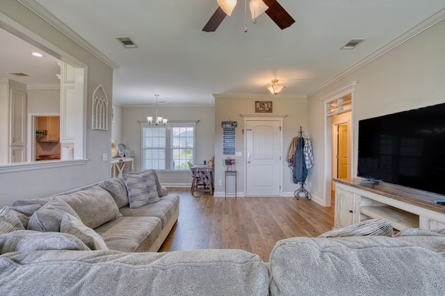 living room with baseboards, light wood-style floors, visible vents, and ceiling fan with notable chandelier