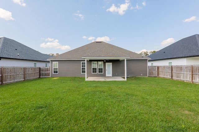 back of property featuring a yard and a patio