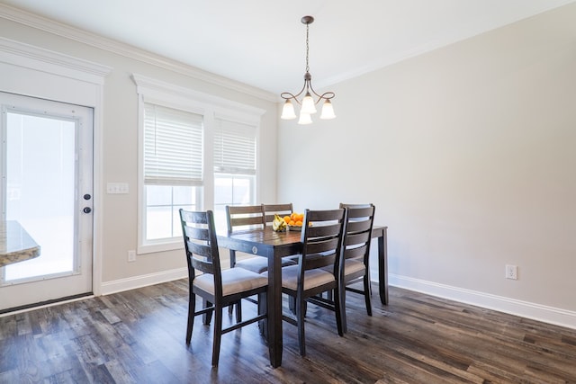 dining room with a chandelier, crown molding, and dark wood-type flooring