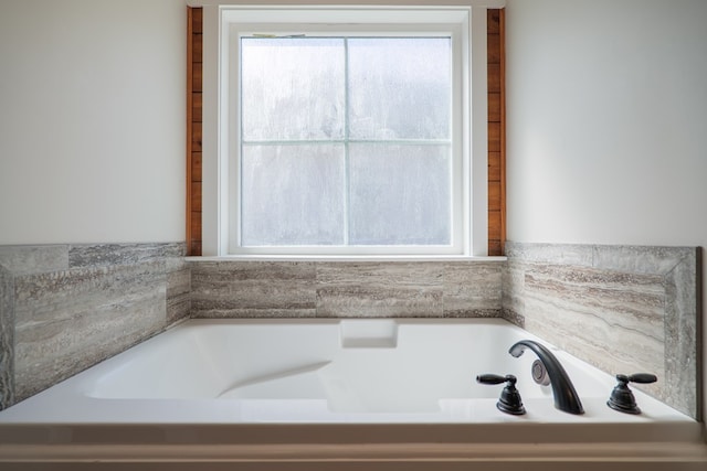 bathroom featuring a bathtub and a wealth of natural light