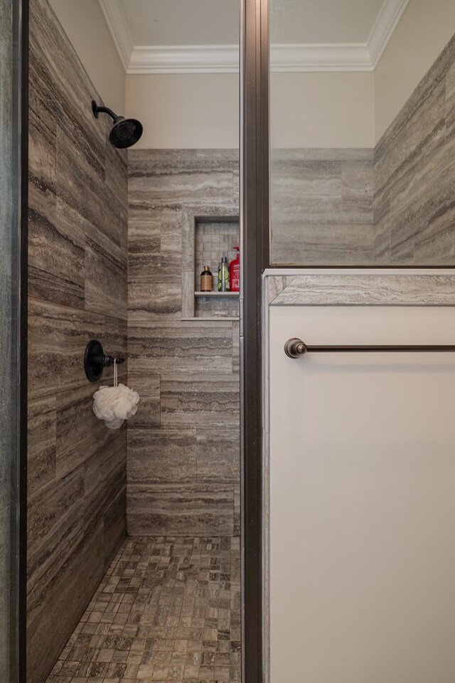 bathroom featuring walk in shower and ornamental molding