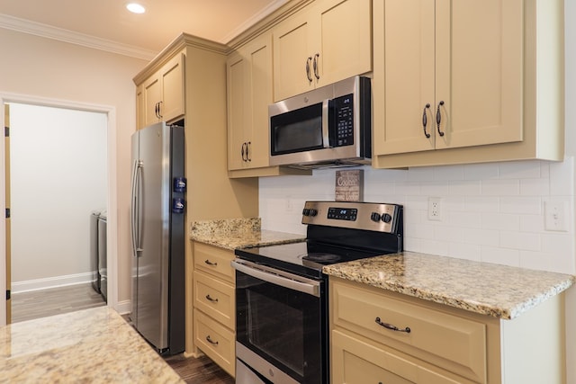 kitchen with hardwood / wood-style flooring, light stone countertops, ornamental molding, and appliances with stainless steel finishes